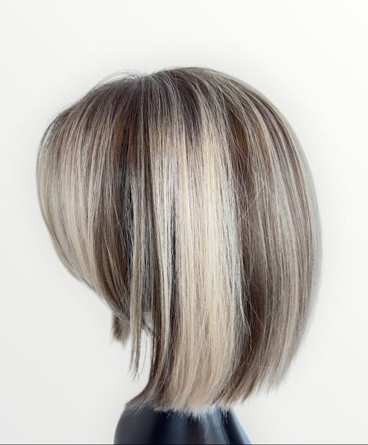 Mannequin head with a styled haircut on a white background