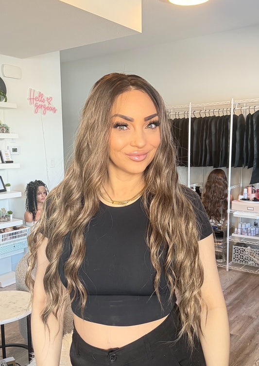 Woman with long wavy hair in a clothing store