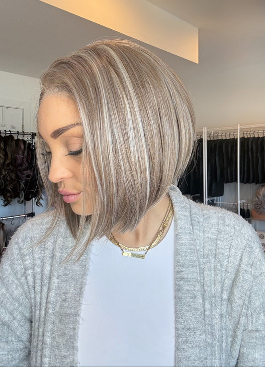 Woman with styled hair in a salon setting