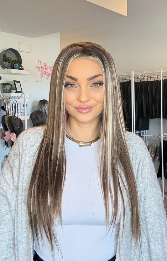 Woman with long hair standing in a hair salon.
