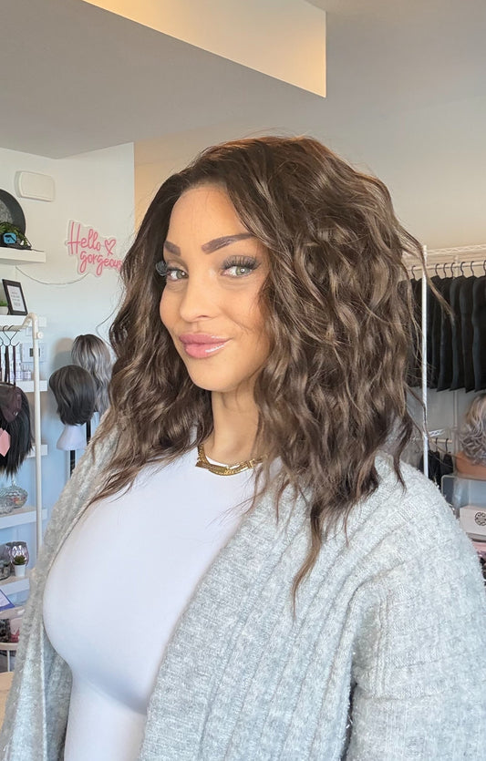 Woman with styled hair in a hair salon setting