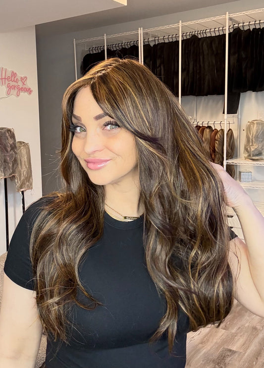 Woman with long brown hair in a store setting