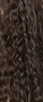 Woman with long, wavy hair in a hair salon setting