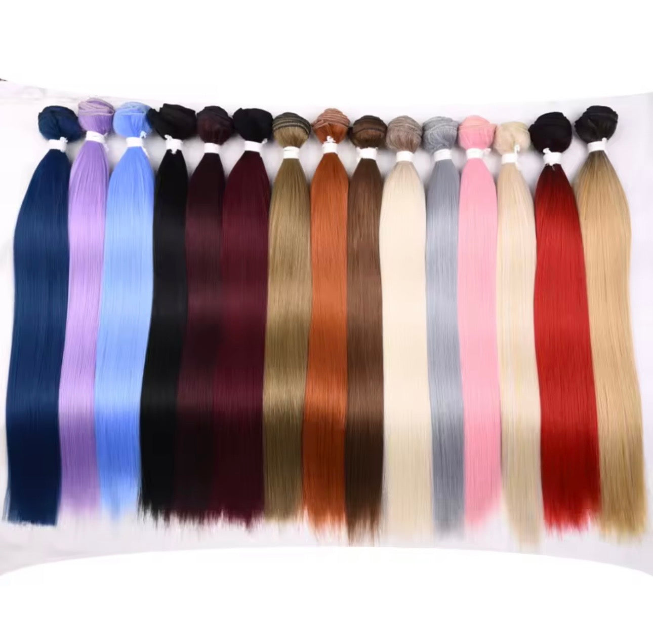 Assorted colors of hair extensions displayed on a white background