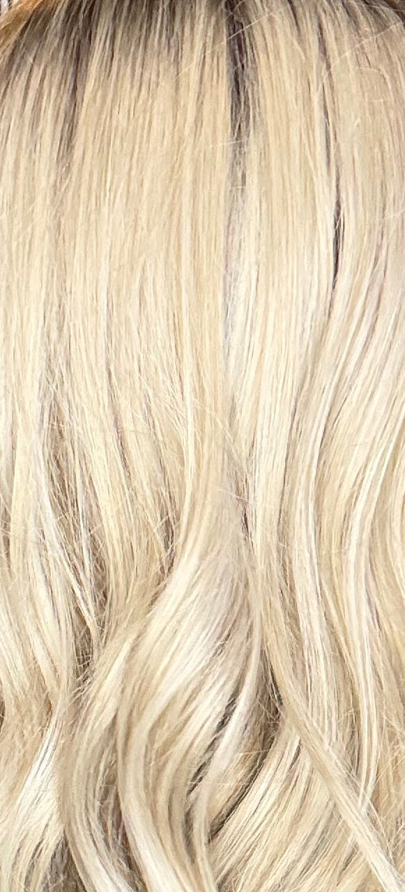 Person with blonde hair styled in a salon setting