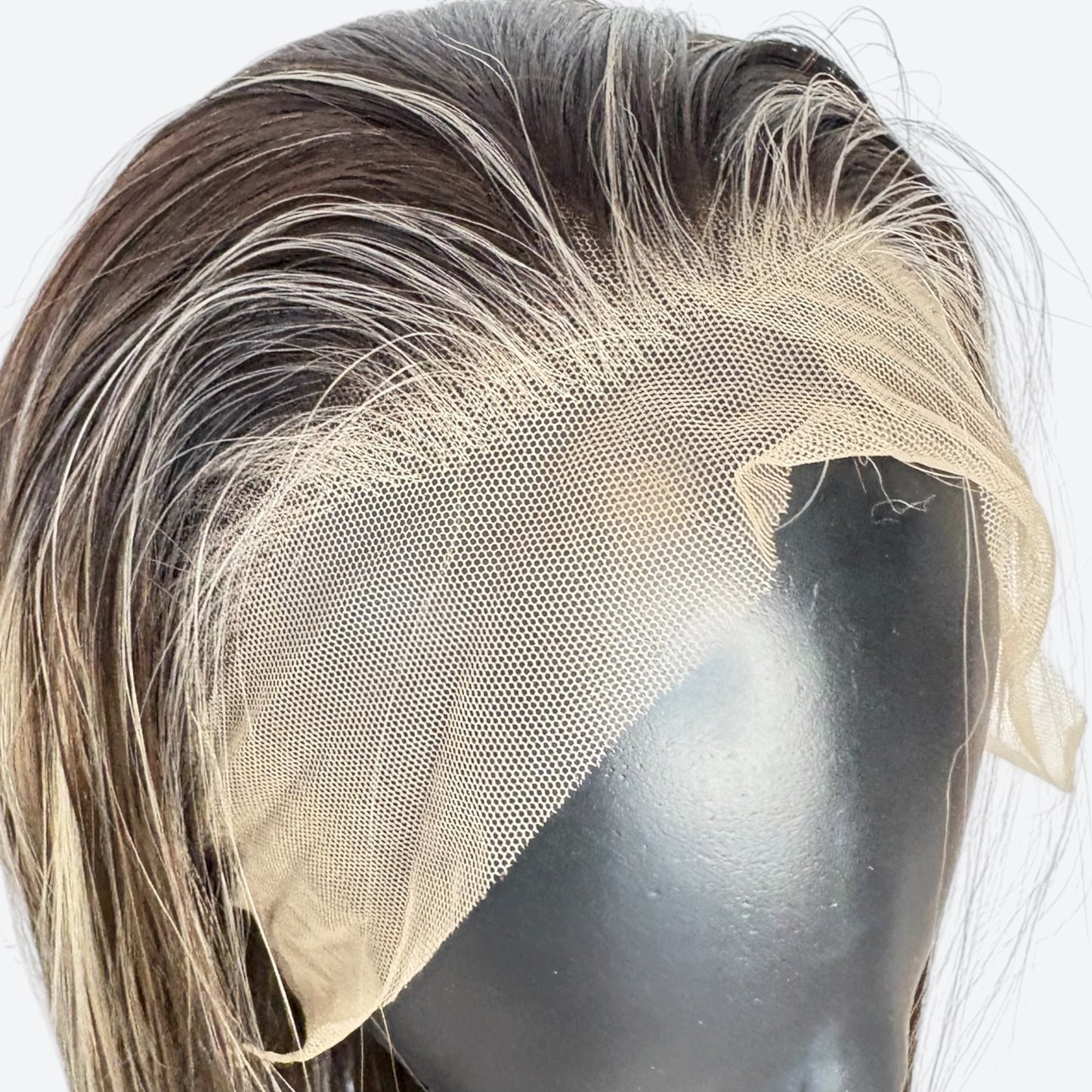 Mannequin head with a wig featuring brown and blonde hair on a white background