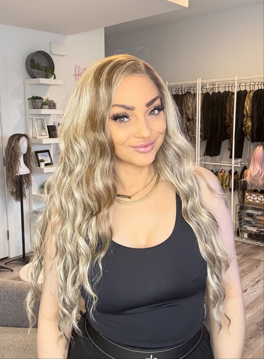 Woman with long, wavy hair in a salon setting