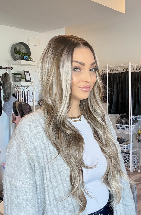 Woman with long blonde hair standing in a clothing store