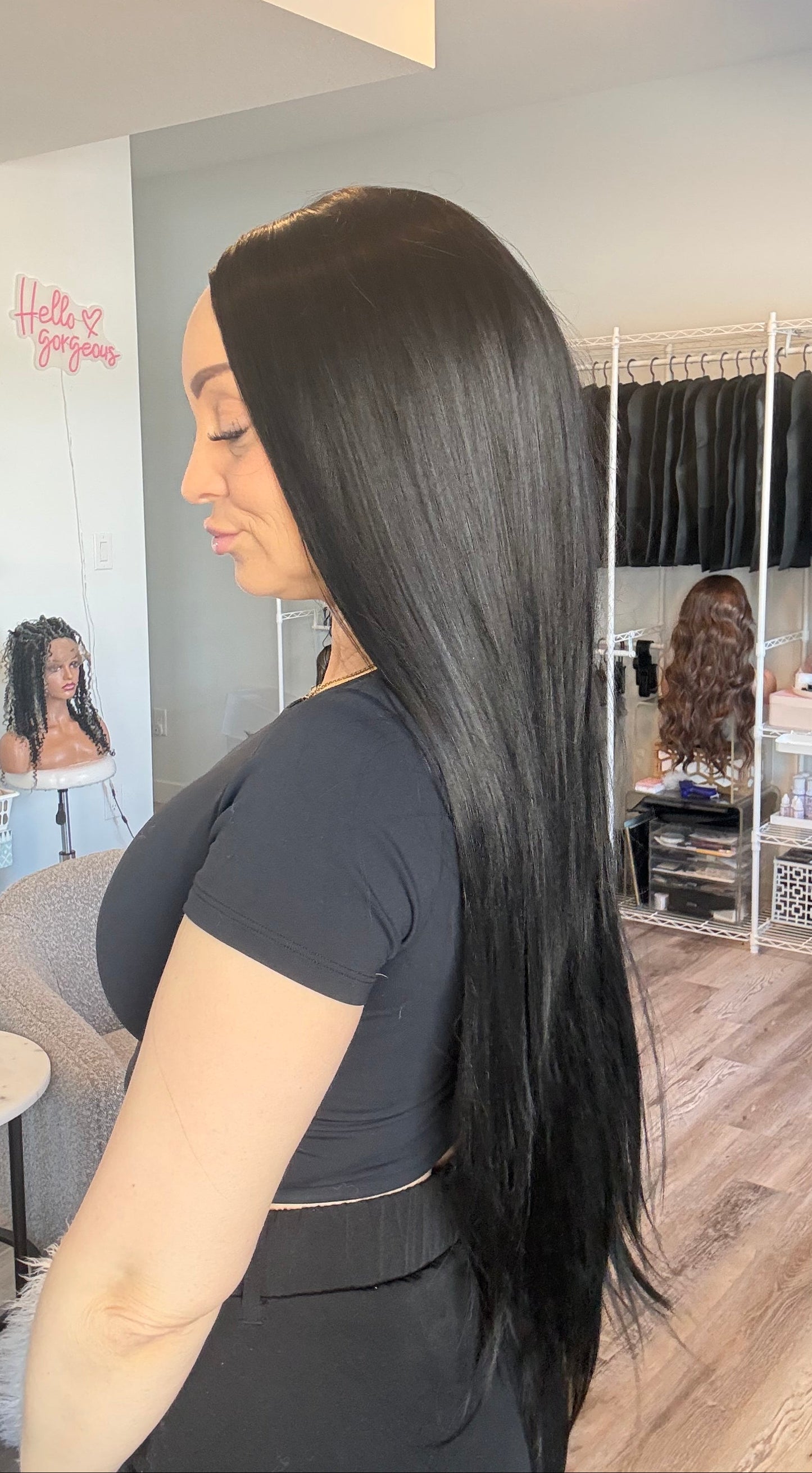 Woman with long black hair in a salon setting