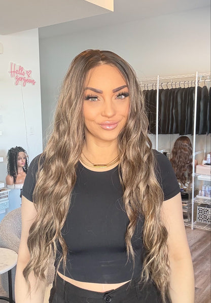 Woman with long wavy hair in a salon setting