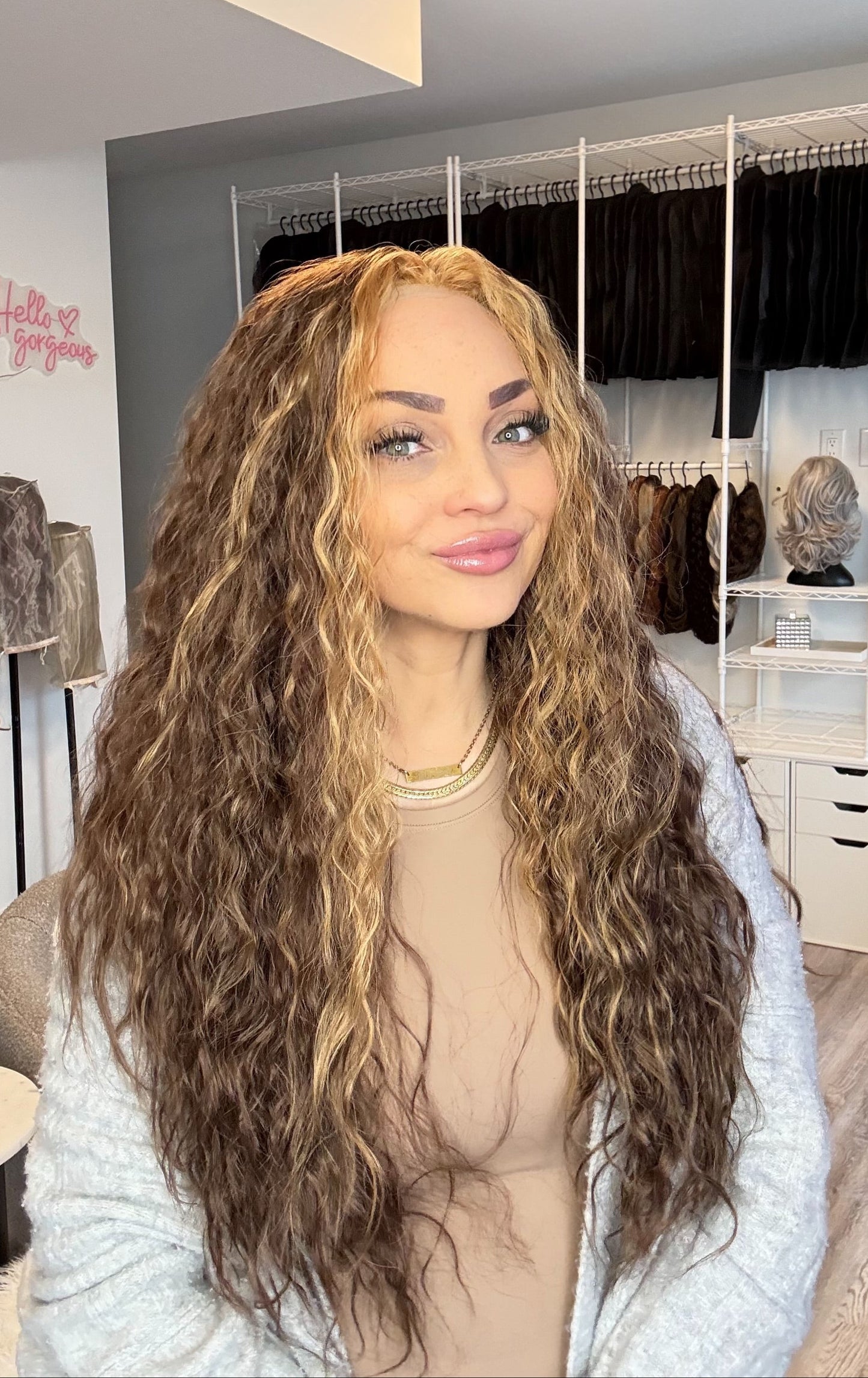 Person with long, wavy hair in a wig store setting