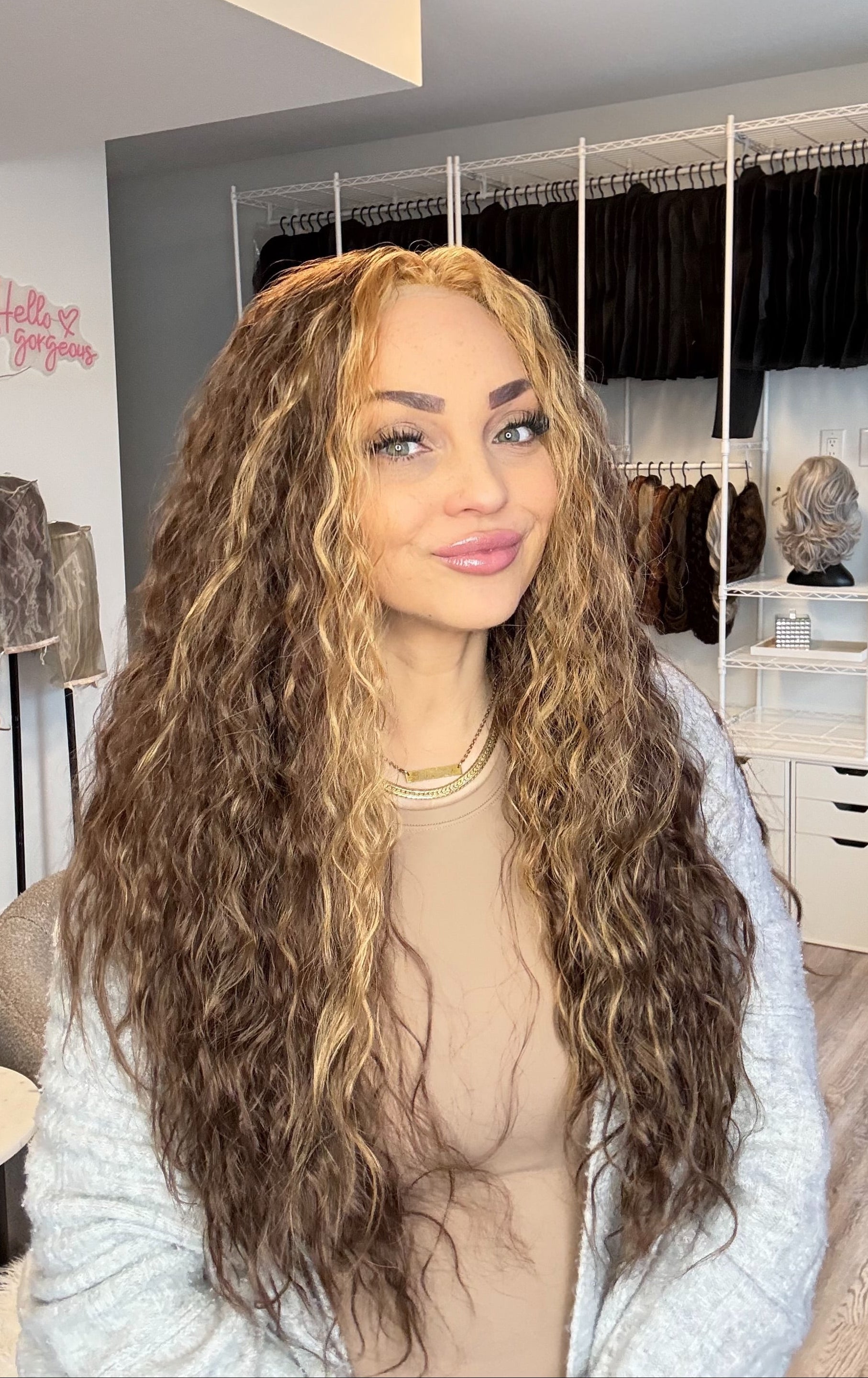 Person with long, wavy hair in a wig store setting