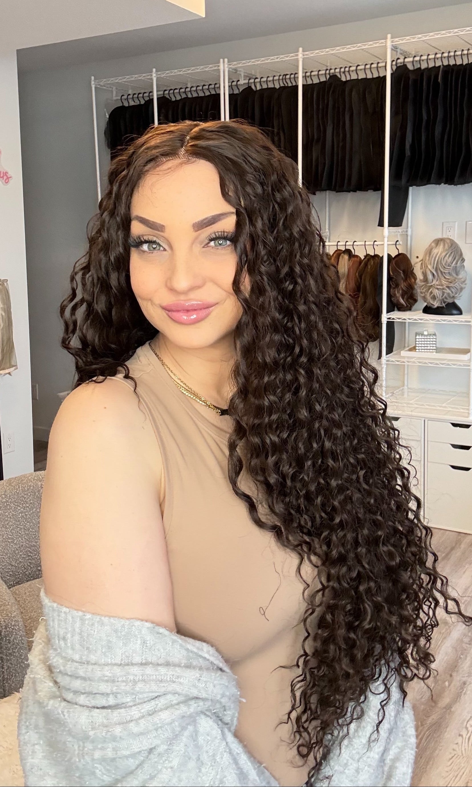 Woman with long, curly hair in a hair salon setting