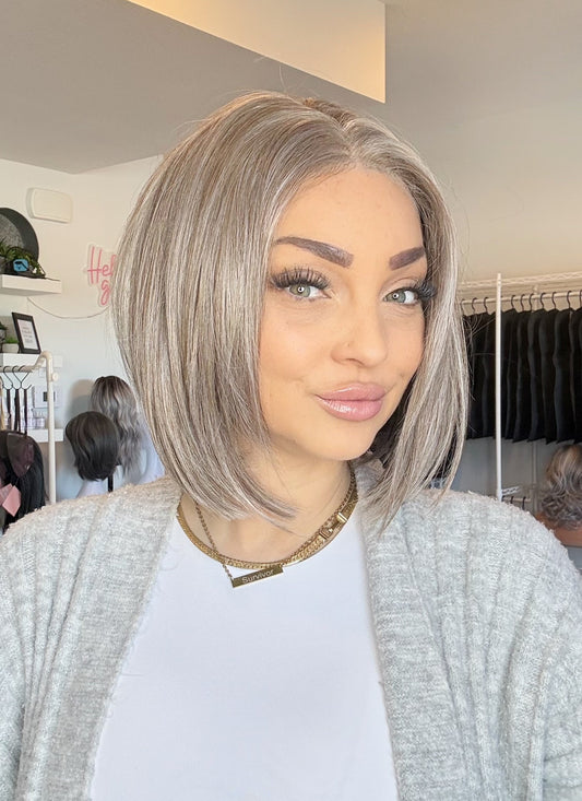Woman with styled hair in a salon setting