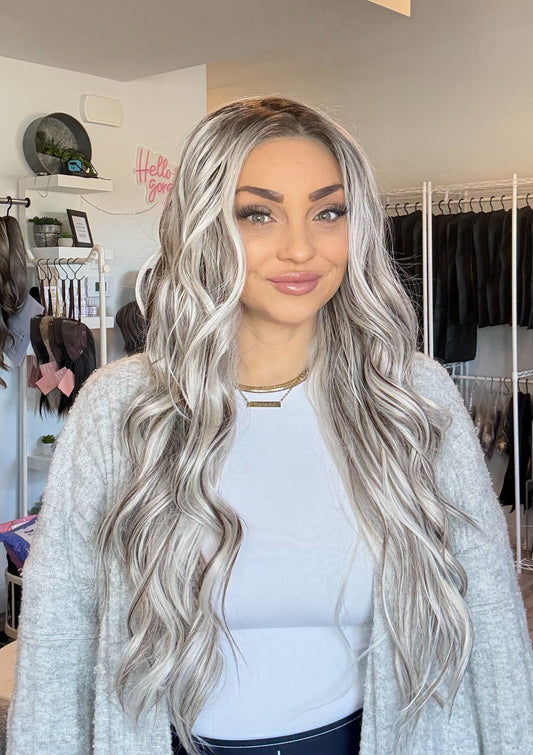 Woman with long, wavy hair in a clothing store