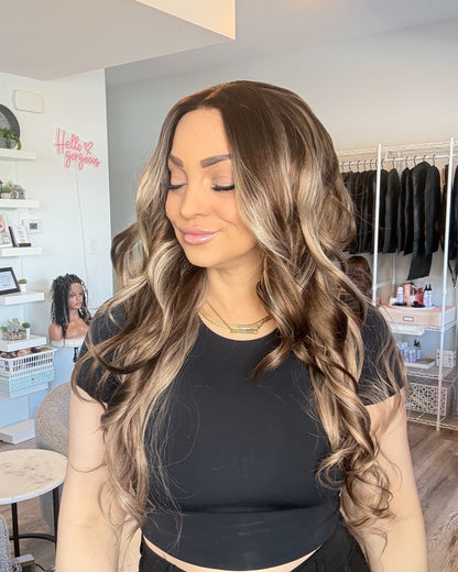 Woman with long, wavy hair in a salon setting