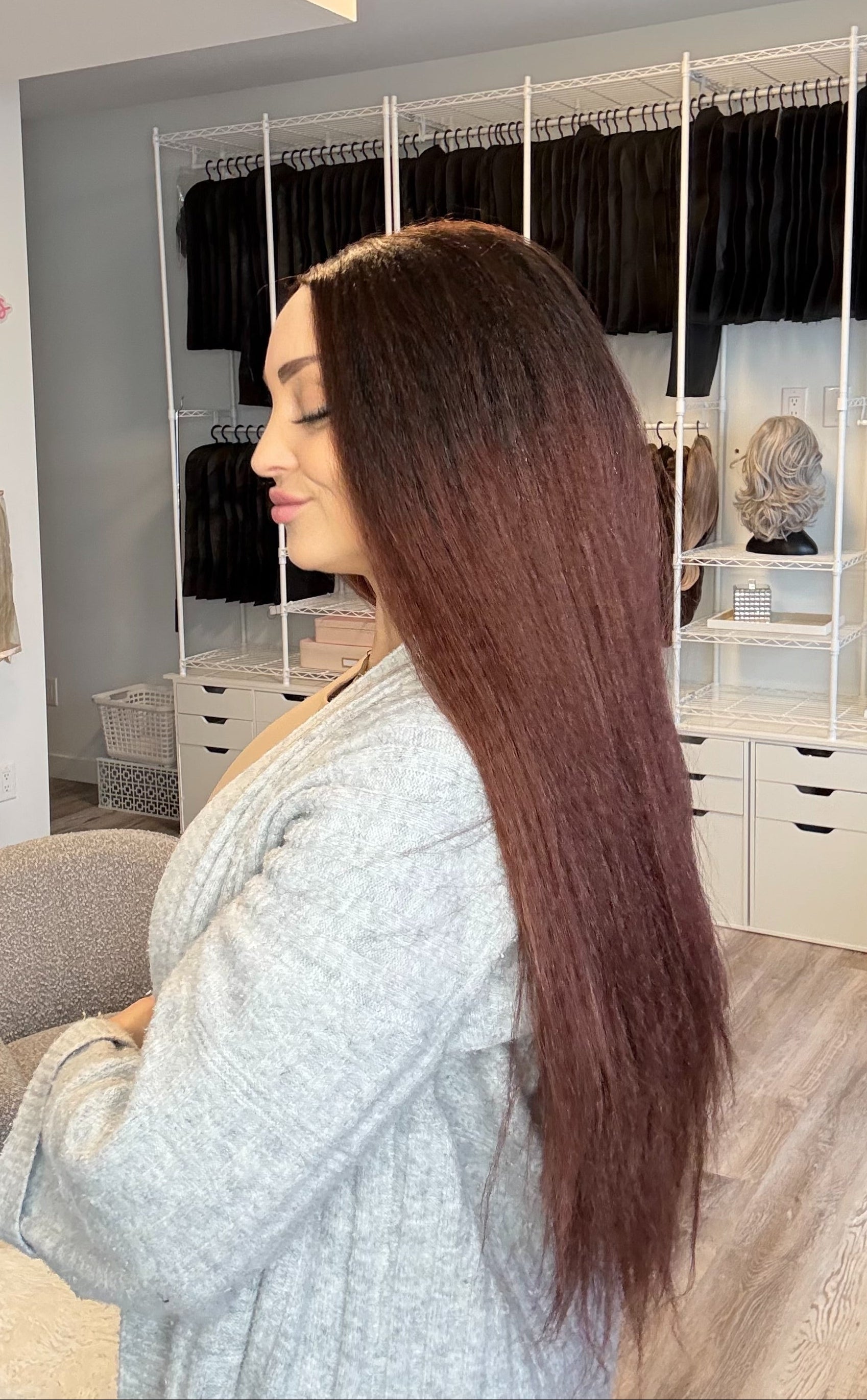 Woman with long brown hair in a salon setting