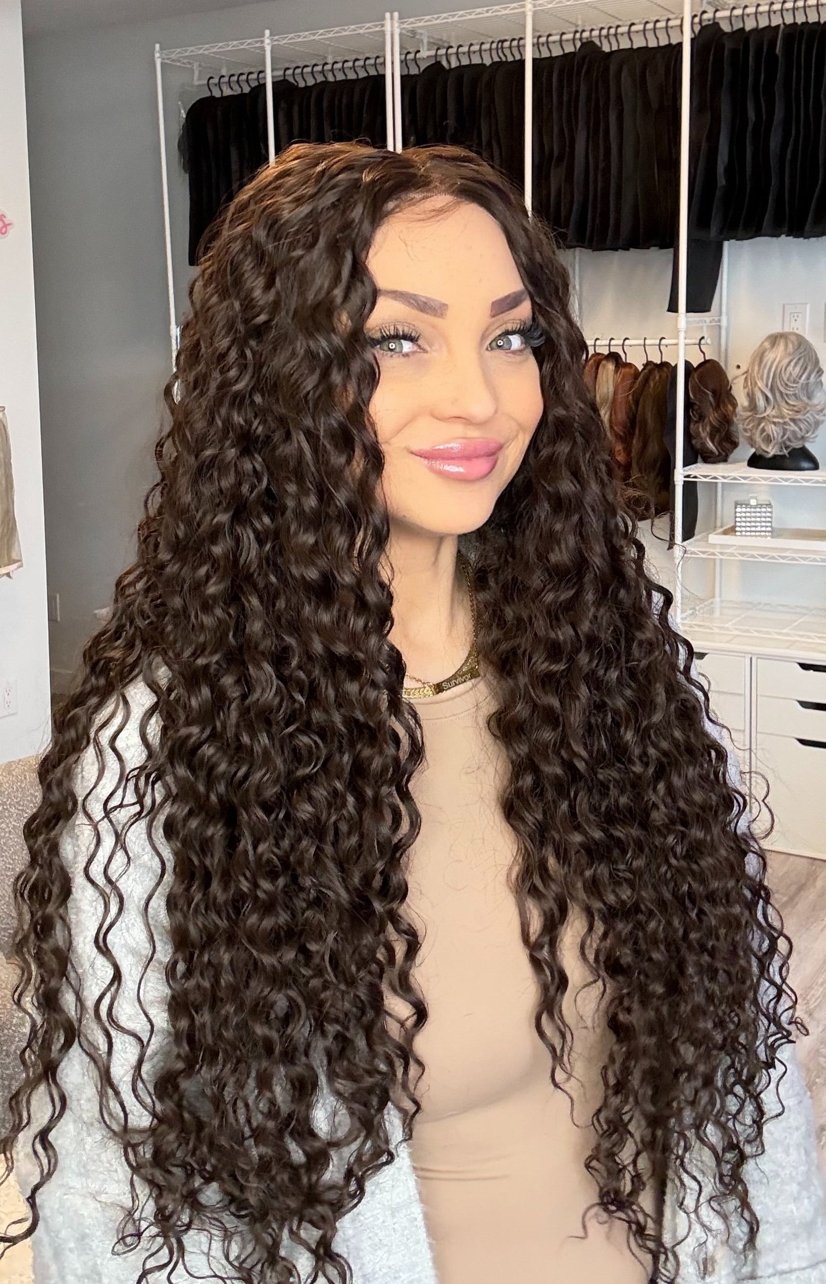 Woman with long, curly hair in a hair salon setting