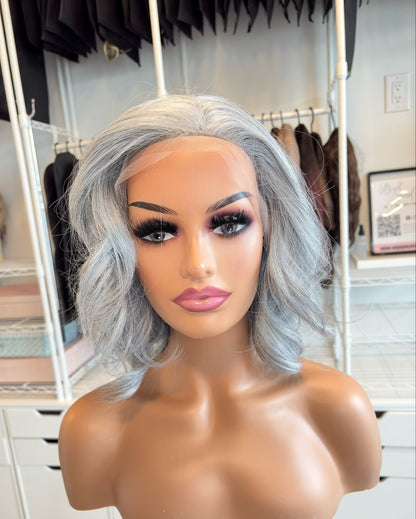 Mannequin head with gray wig in a room setting