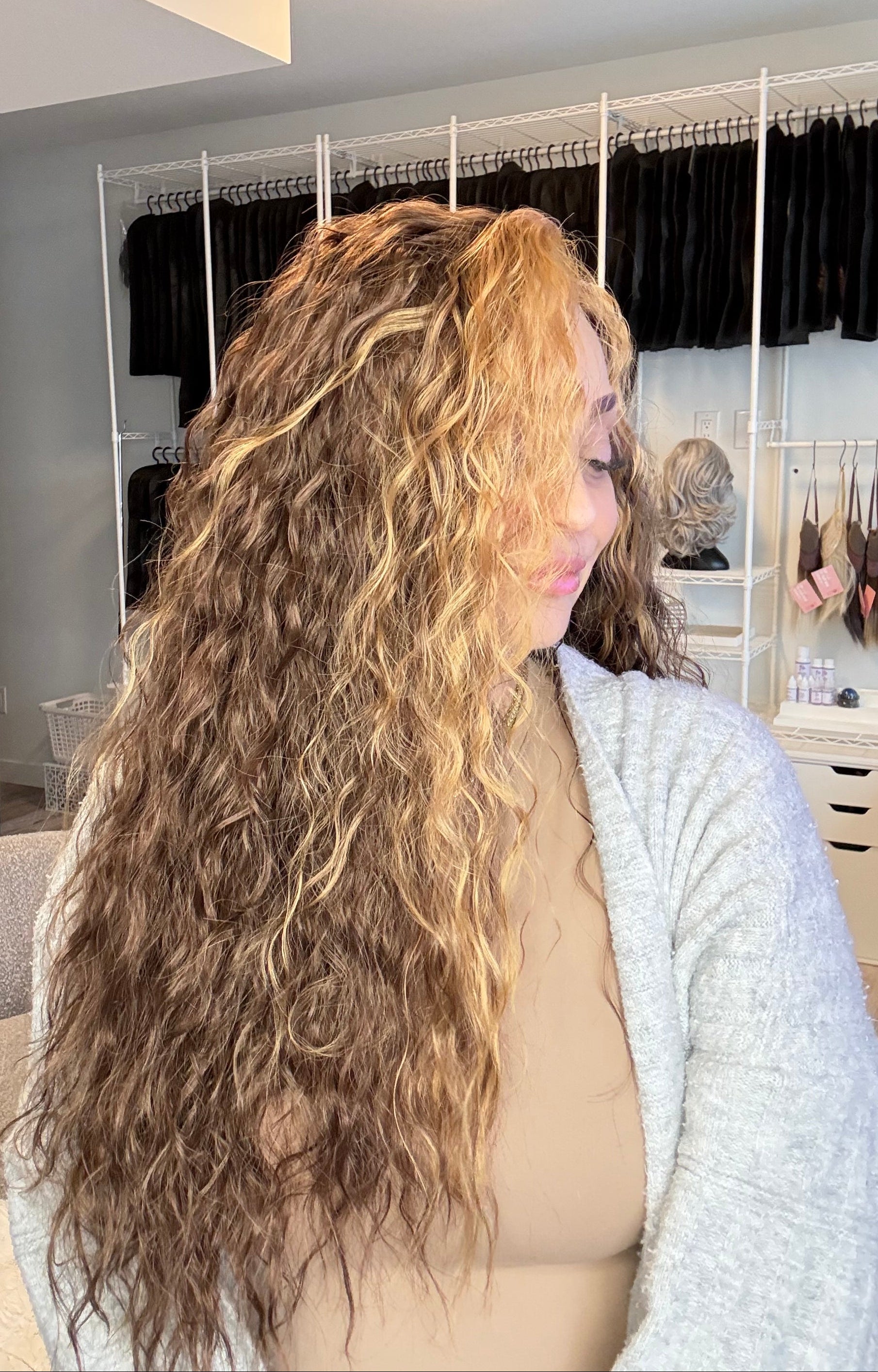 Person with long hair in a bedroom setting