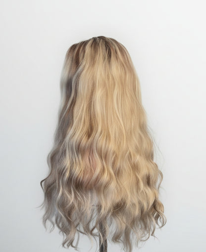 Blonde wig with wavy hair on a white background