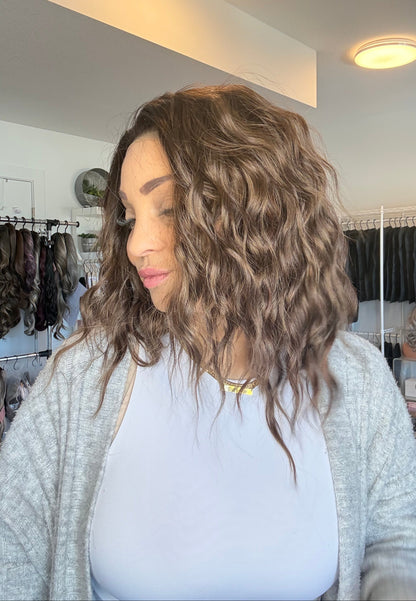 Person with wavy hair in a salon setting