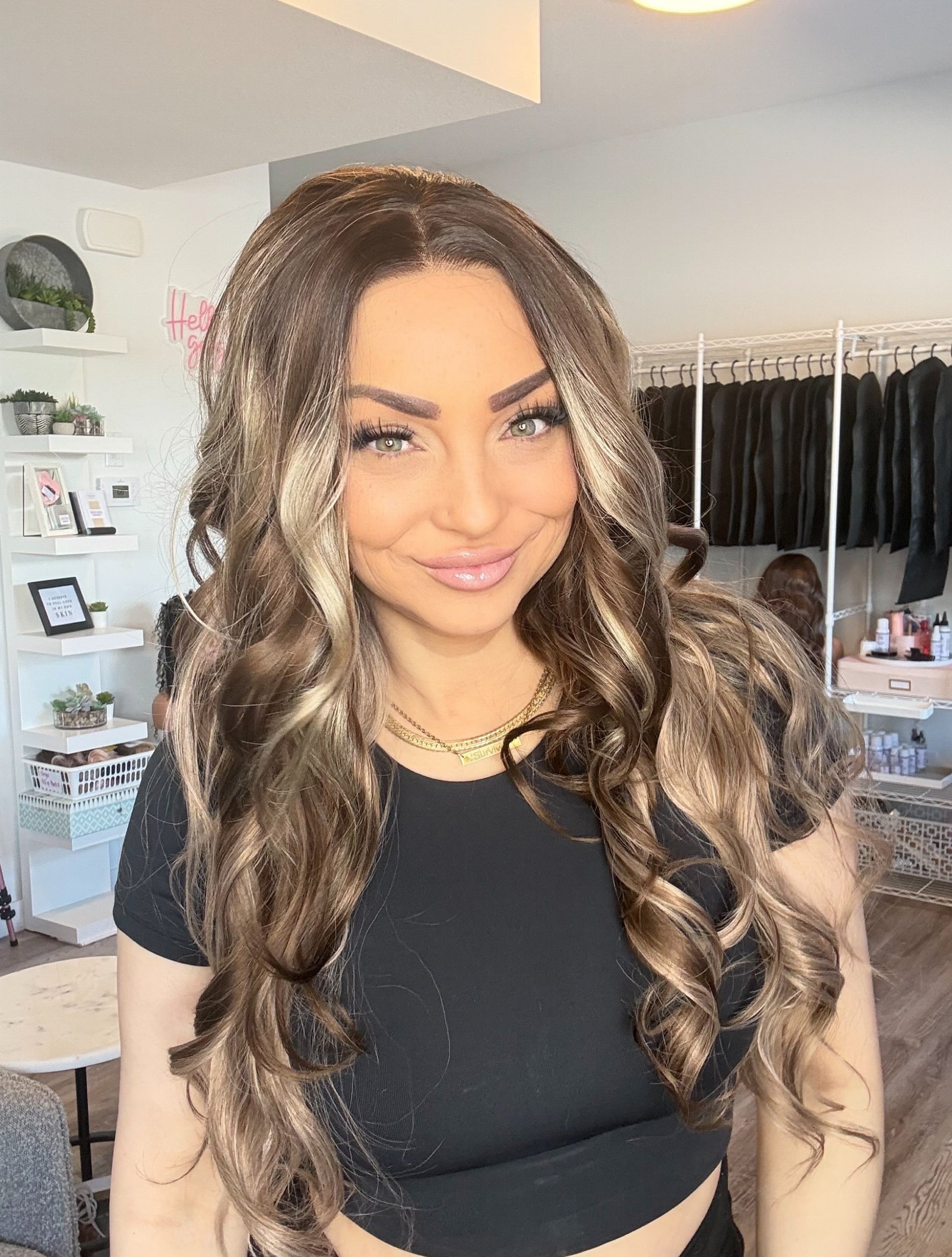 Woman with long, wavy hair in a clothing store
