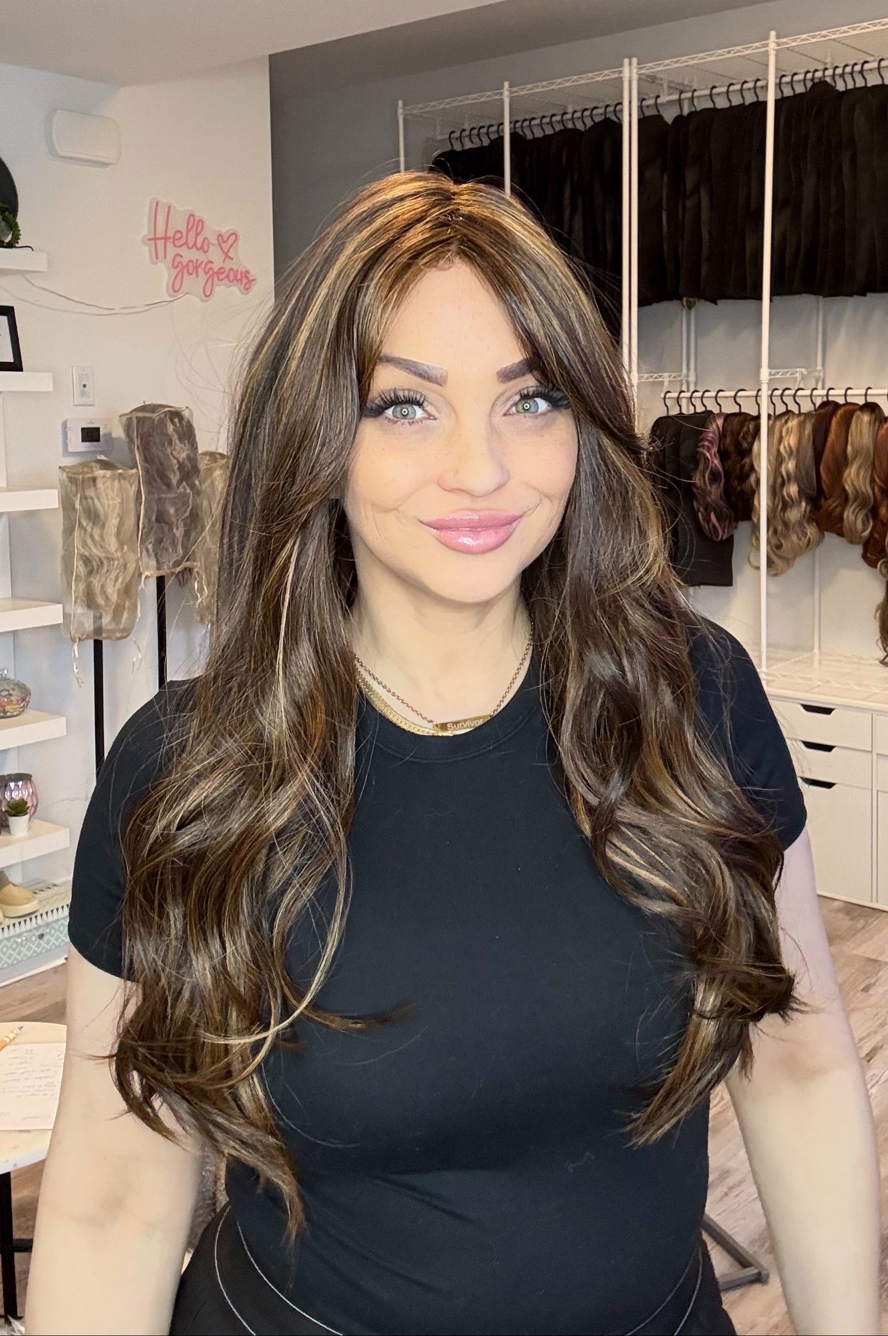 Woman with long brown hair in a hair salon setting