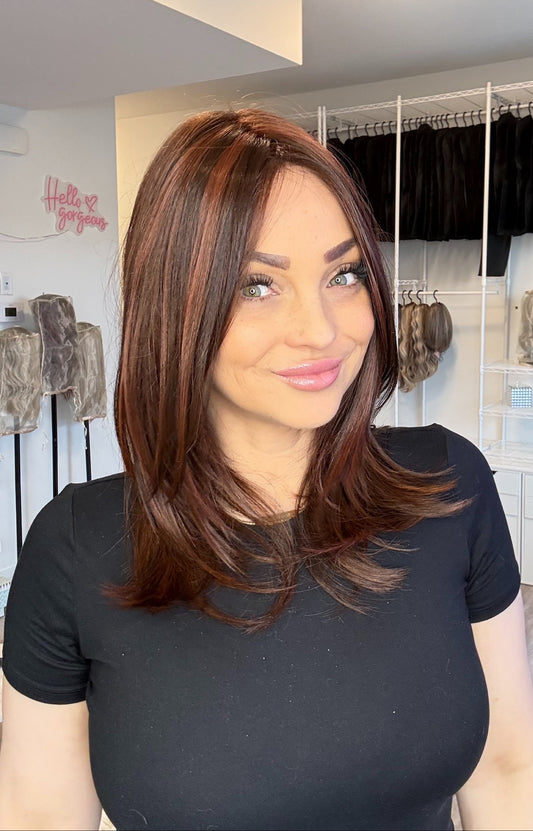 Woman with styled hair in a hair salon setting