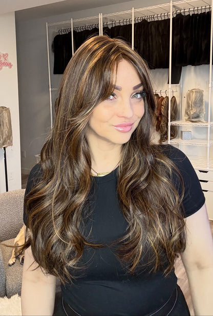 Woman with long, wavy hair in a clothing store