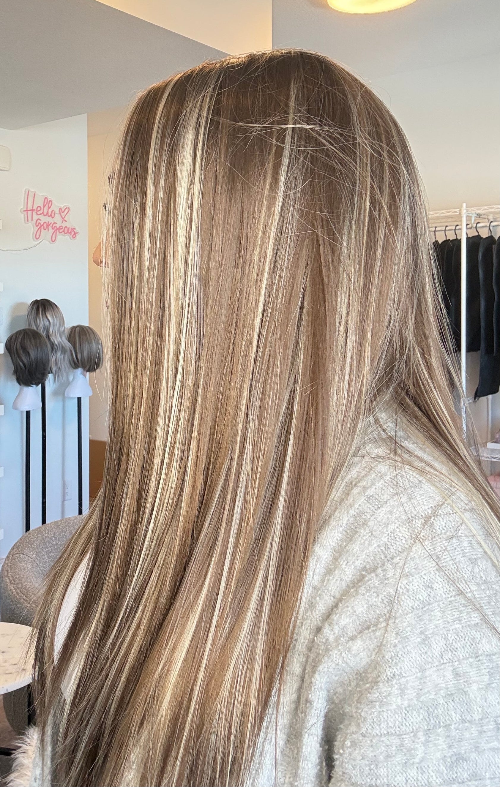 Person with long, straight hair in a salon setting