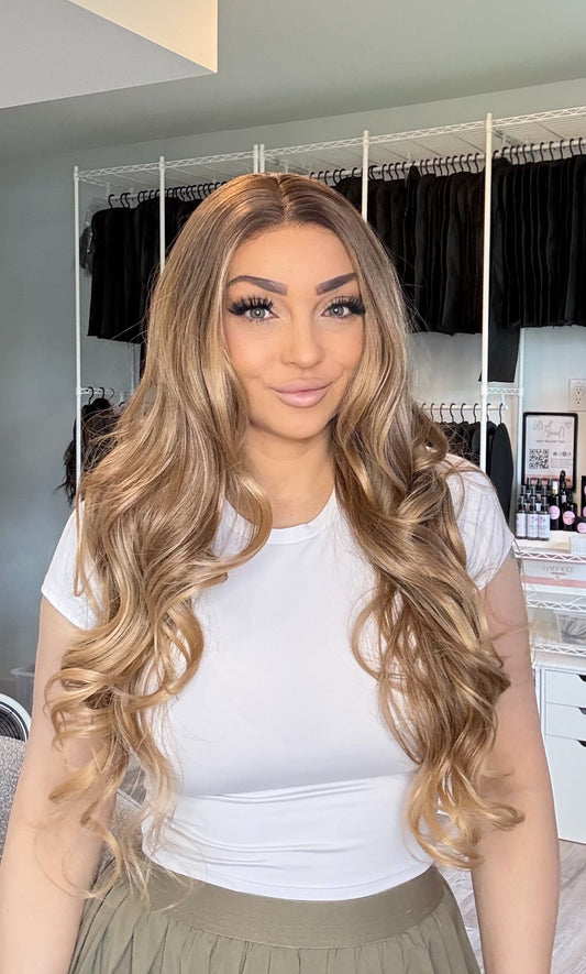 Alex: a 28 inch dimensional blonde 13x4 lace front wig with soft golden tones. Transparent French lace, 150% density, heat-safe fibres. Free shipping $150+.