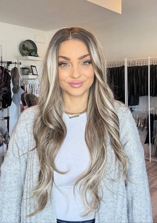 Woman with long, wavy hair in a clothing store