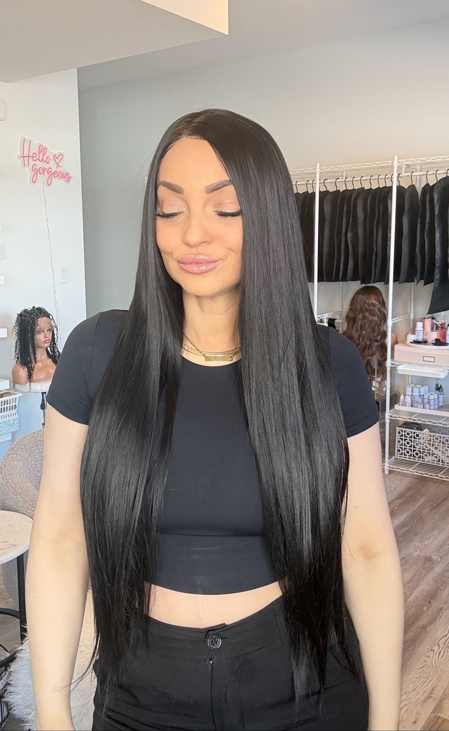 Woman with long black hair in a salon setting