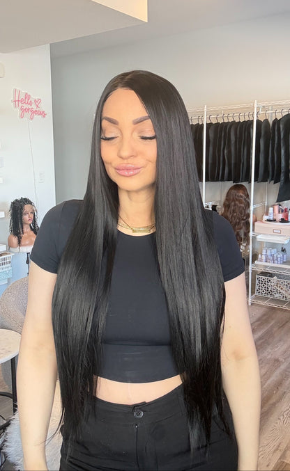 Woman with long black hair in a salon setting