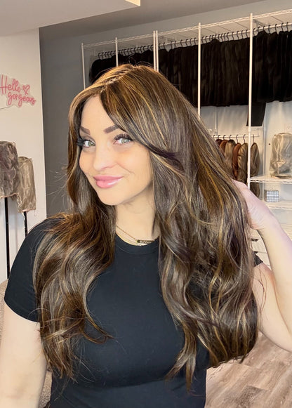 Woman with long brown hair in a store setting