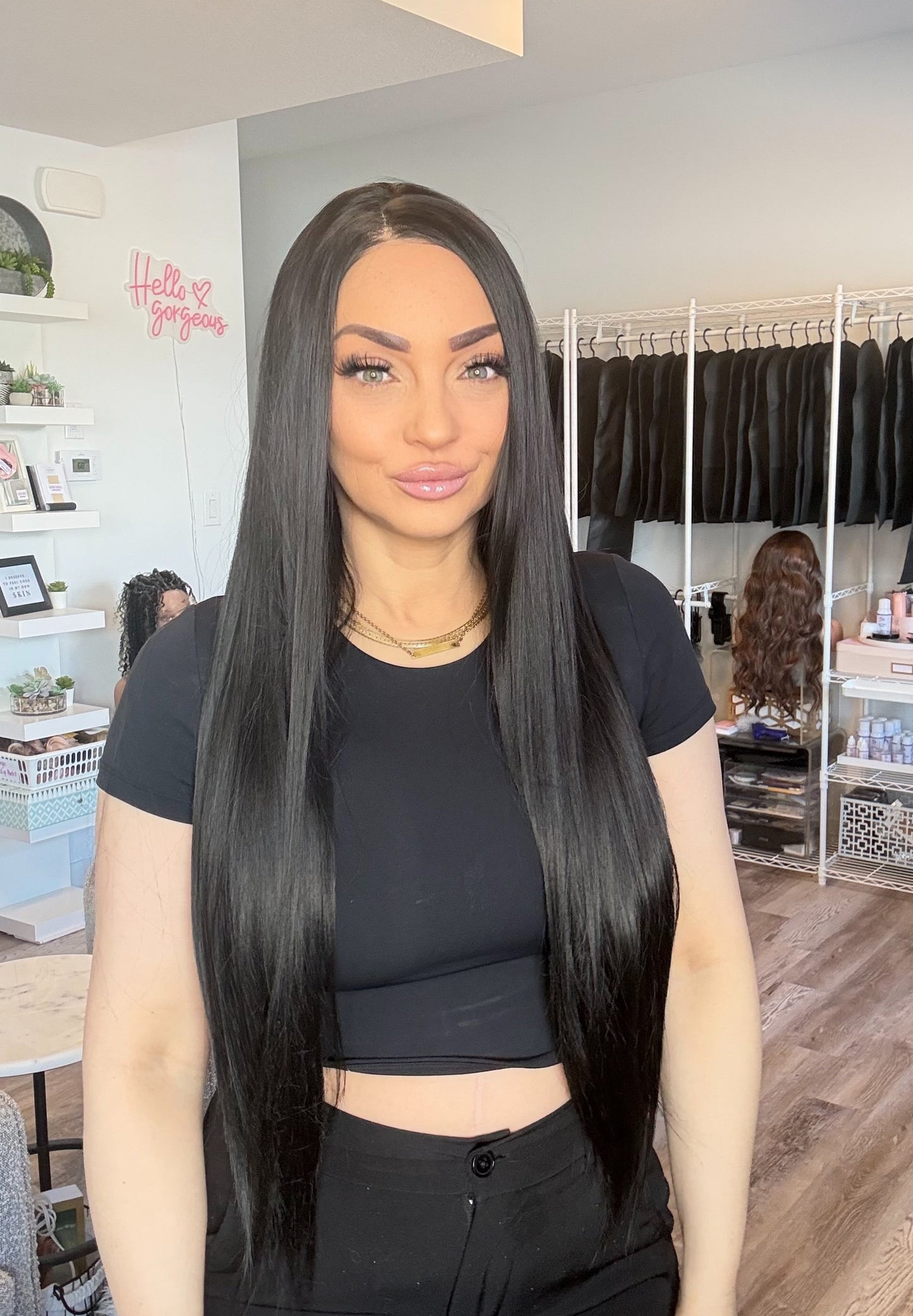 Person with long black hair in a salon setting
