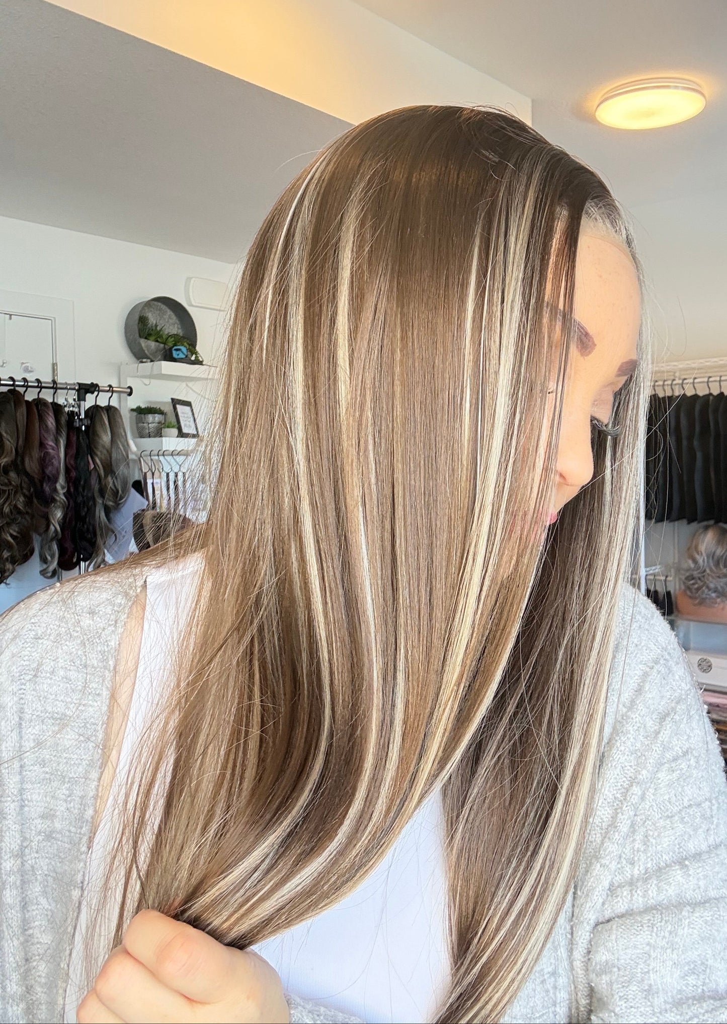 Person with long, straight hair in a salon setting