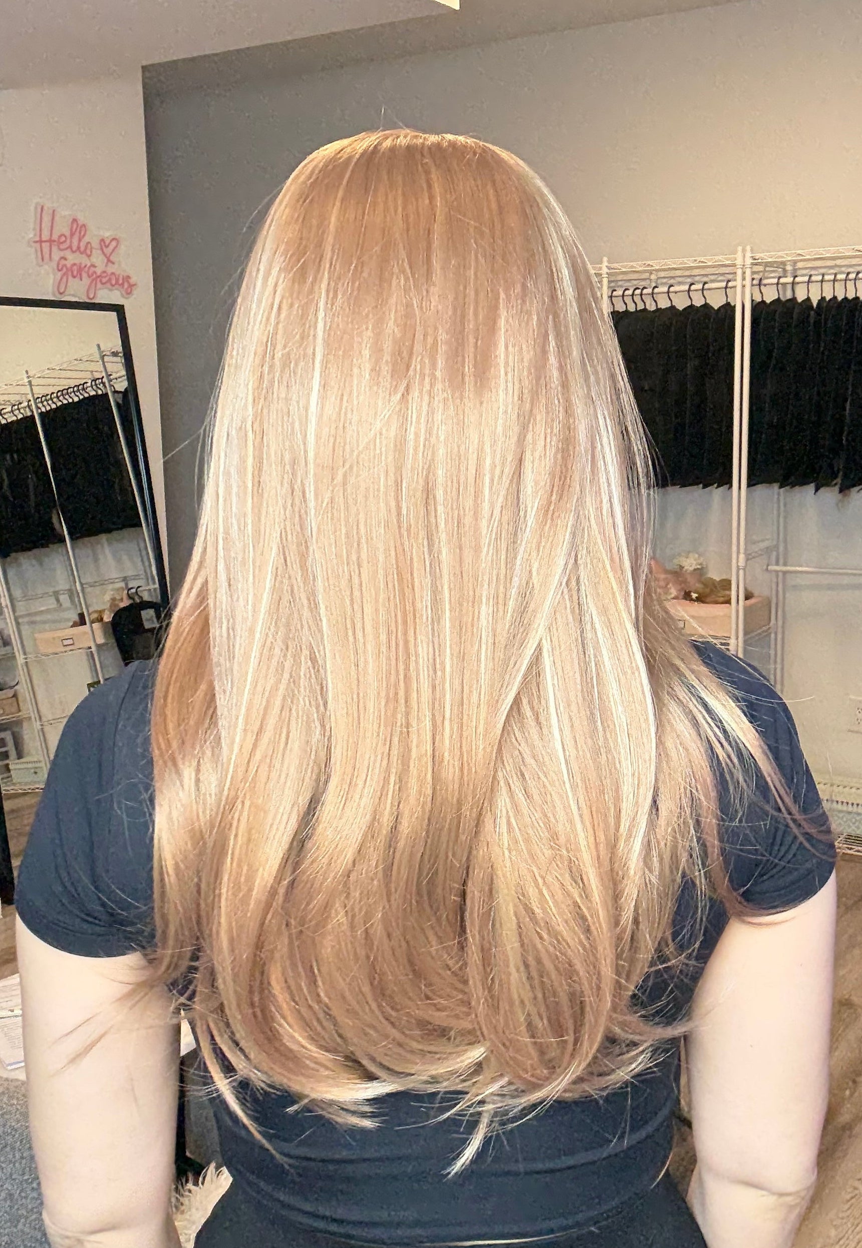Person with long blonde hair in a salon setting