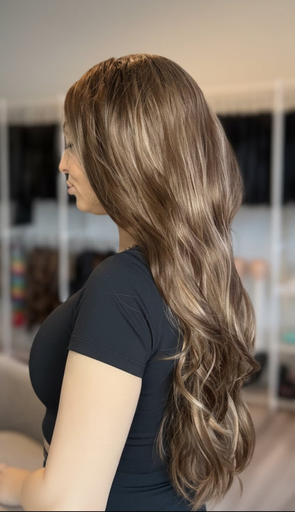 Woman with long, wavy hair in a salon setting