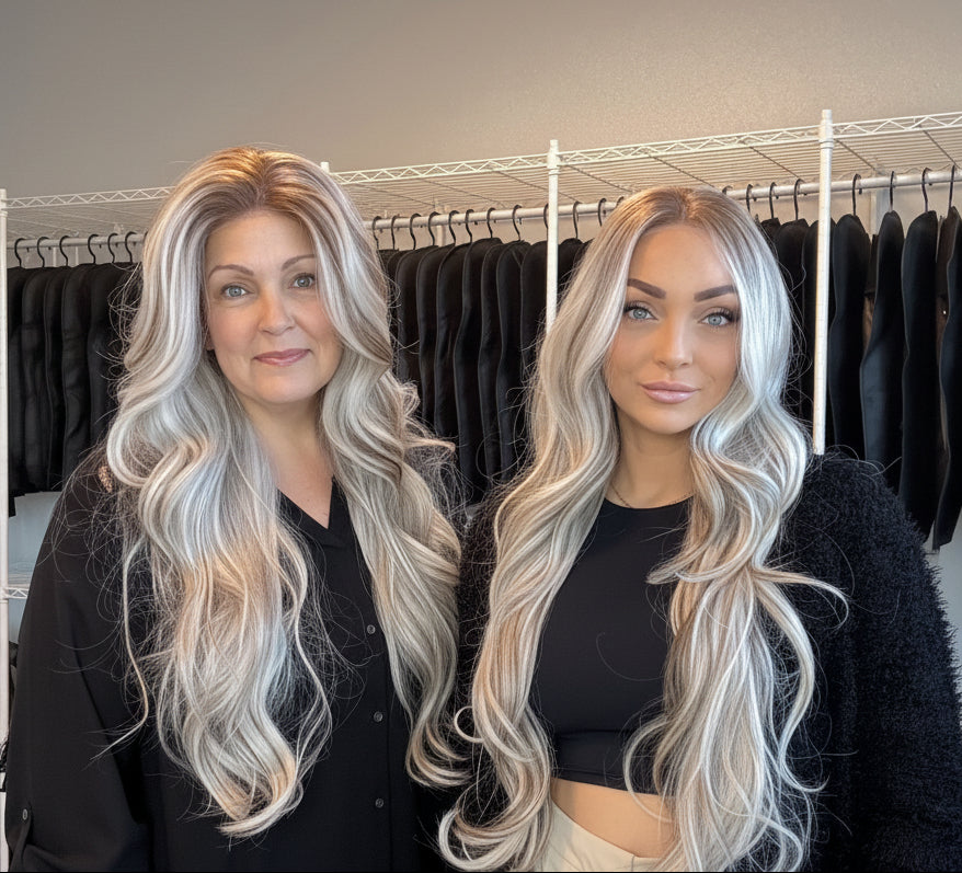 Two women with styled hair standing in a clothing store.