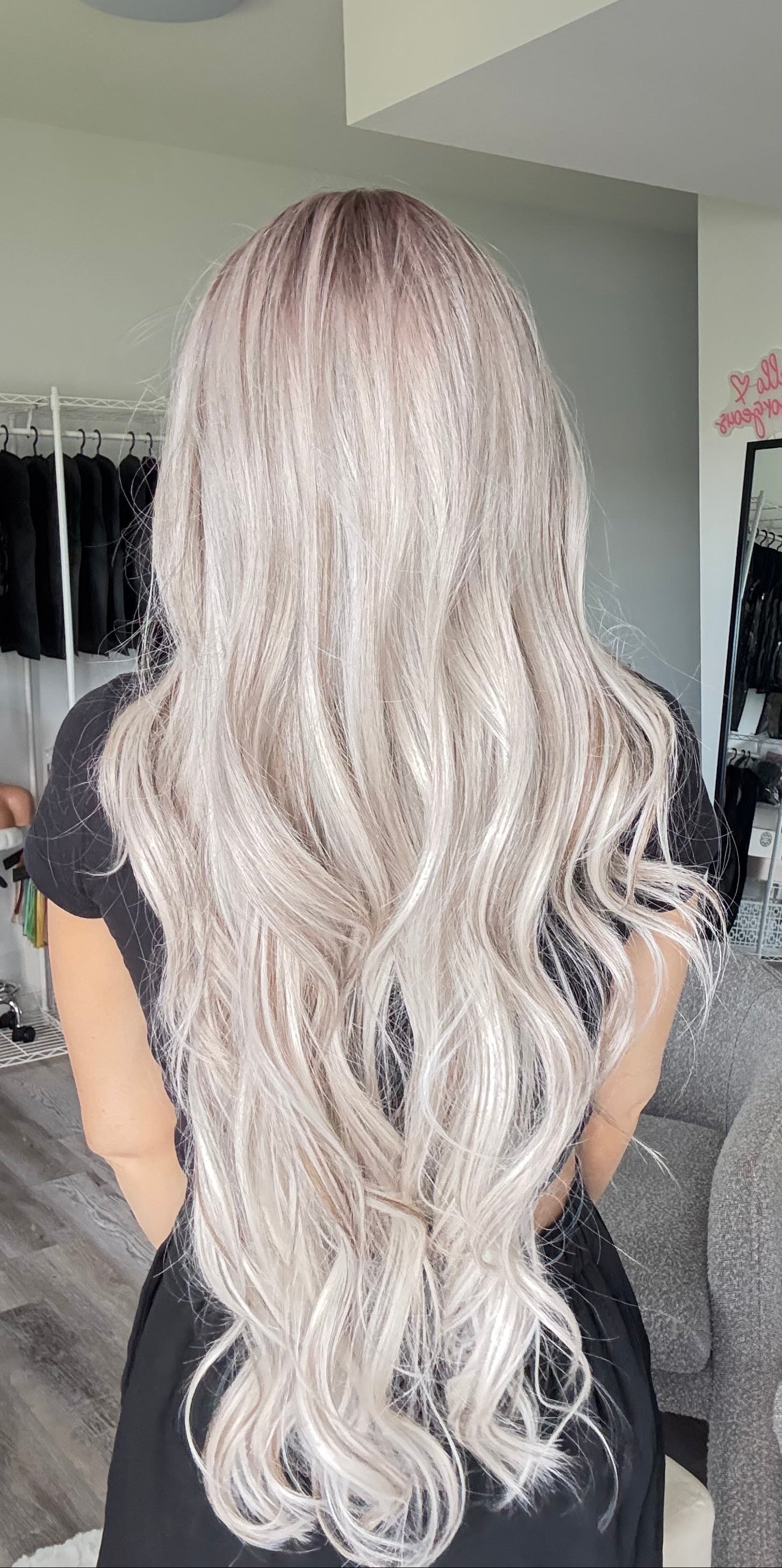 Person with long, wavy hair in a salon setting