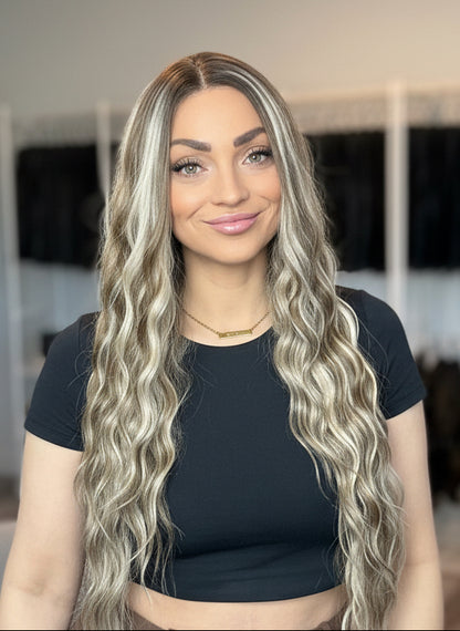 A woman with long wavy hair in a wig store