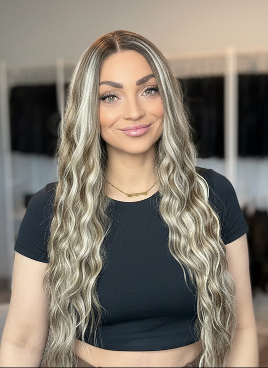 A woman with long wavy hair in a wig store