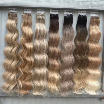 Set of hair extensions with different color shades on a gray background