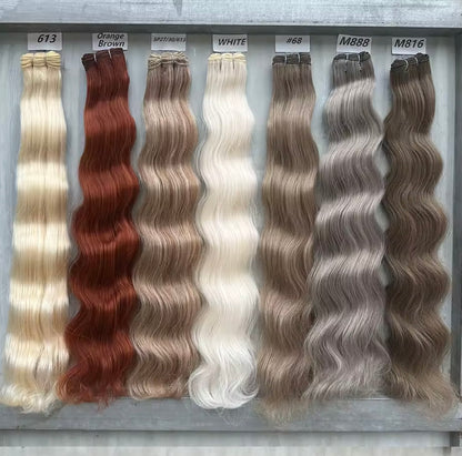 Set of hair extensions in various colors on a gray background