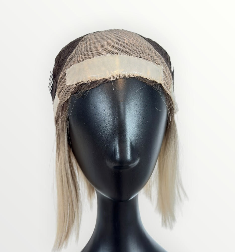 Mannequin head with a wig on a white background