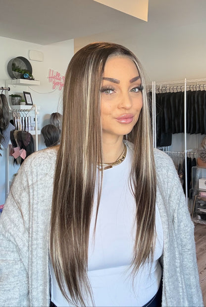 Woman with long straight hair in a hair salon setting