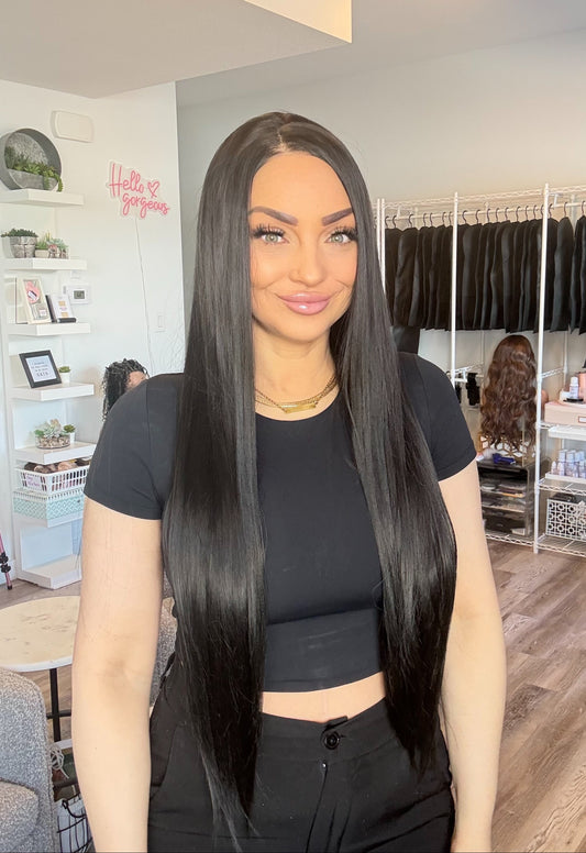 Woman with long black hair in a store setting