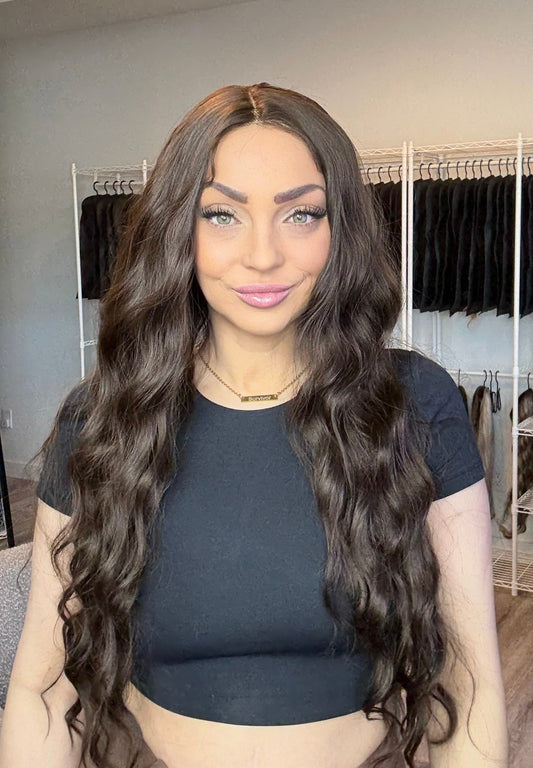 Woman with long wavy hair in a wig store